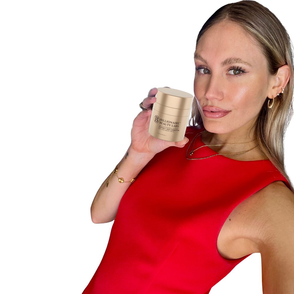 Woman holding Billionaire Beauty Labs Cream container with a plain backgroung