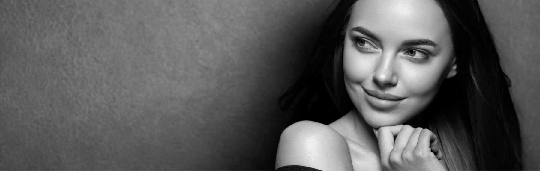 Black and white portrait of a woman with a neutral background
