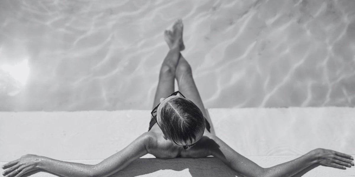 Lady sitting by the pool enjoying a billionaire life style